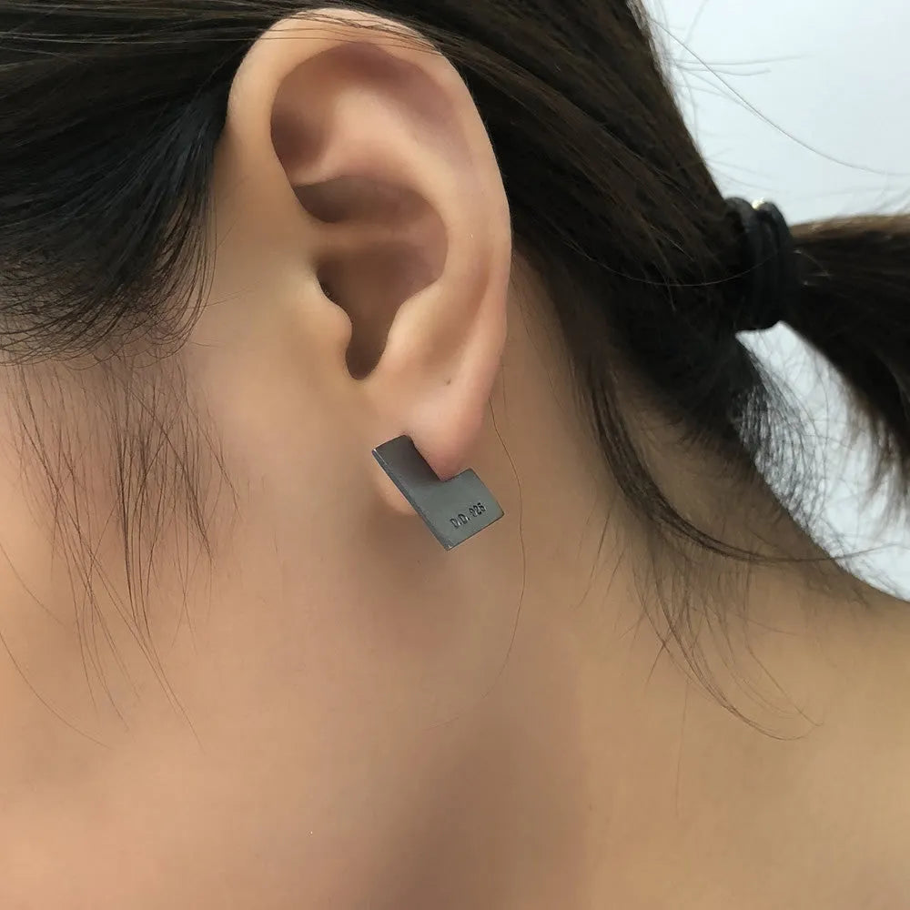 Oxidation black geometric square sterling silver earring ring on a 16mm scale.