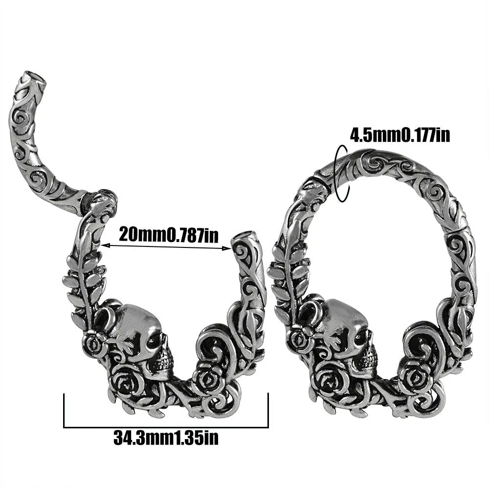 A pair of stainless steel fashion earrings with an intricate totem pattern design in a silver-toned finish.