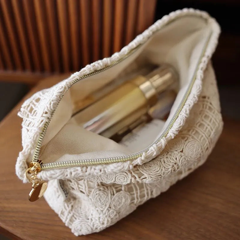 Handmade corduroy cosmetic bag with crochet flowers, ethnic embroidery, and a rope handle.