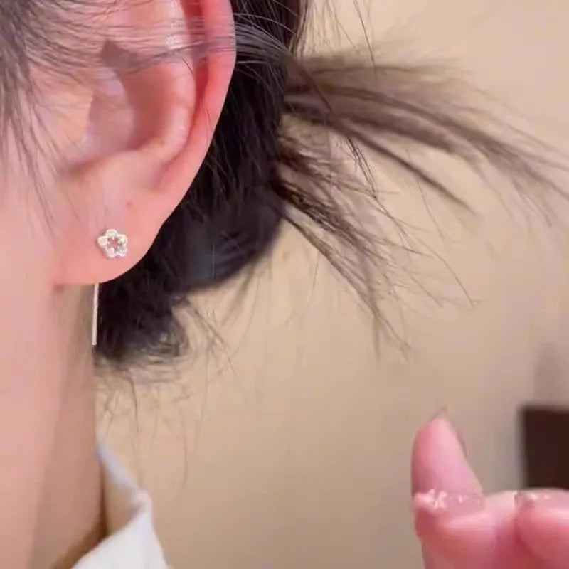 Pair of silver-coloured alloy flower stud earrings with hollow petal design