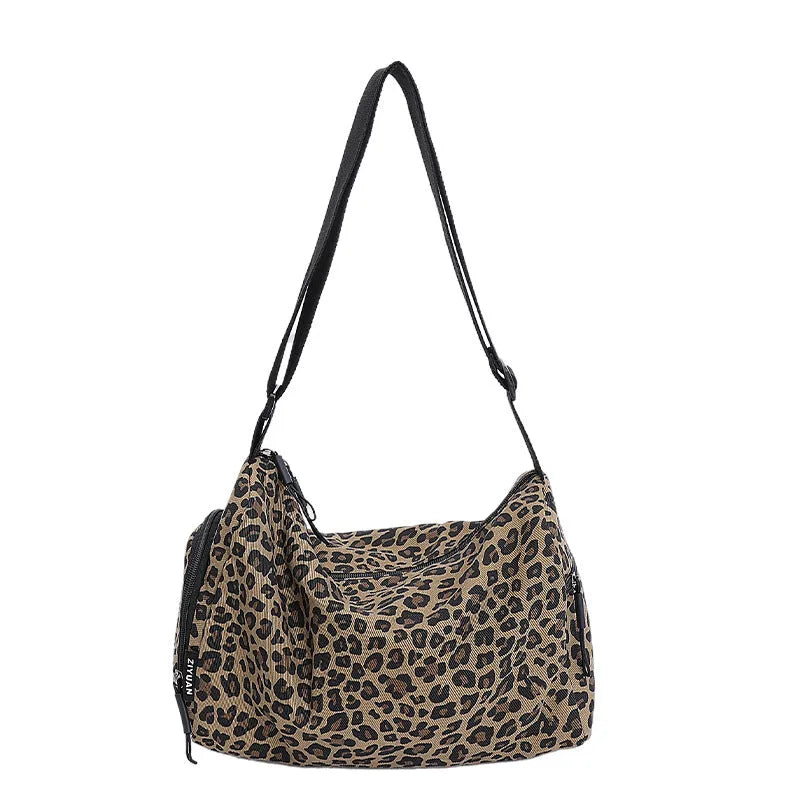 Leopard print sports style shoulder messenger bag with cross-body strap and large main compartment