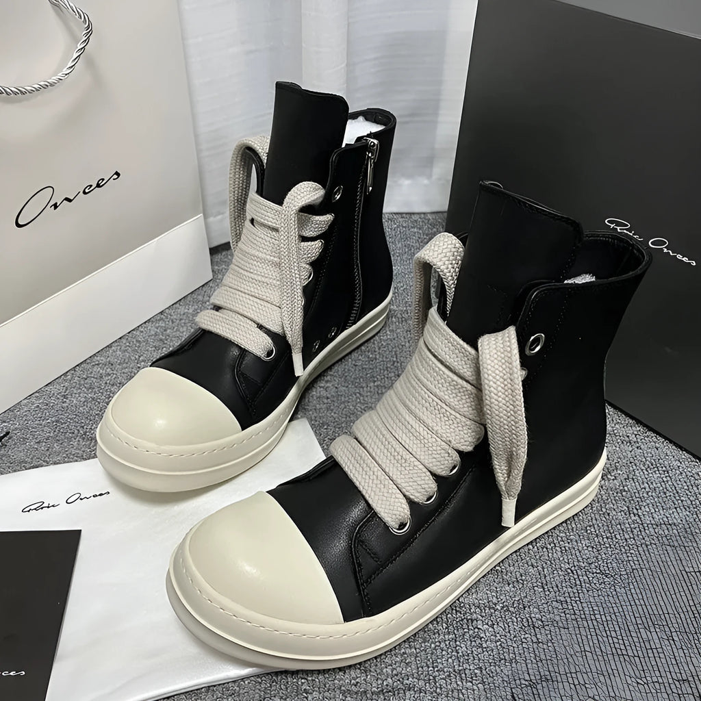 Men's black high-top leather sneakers with side zip, platform sole, and visible stitching details.