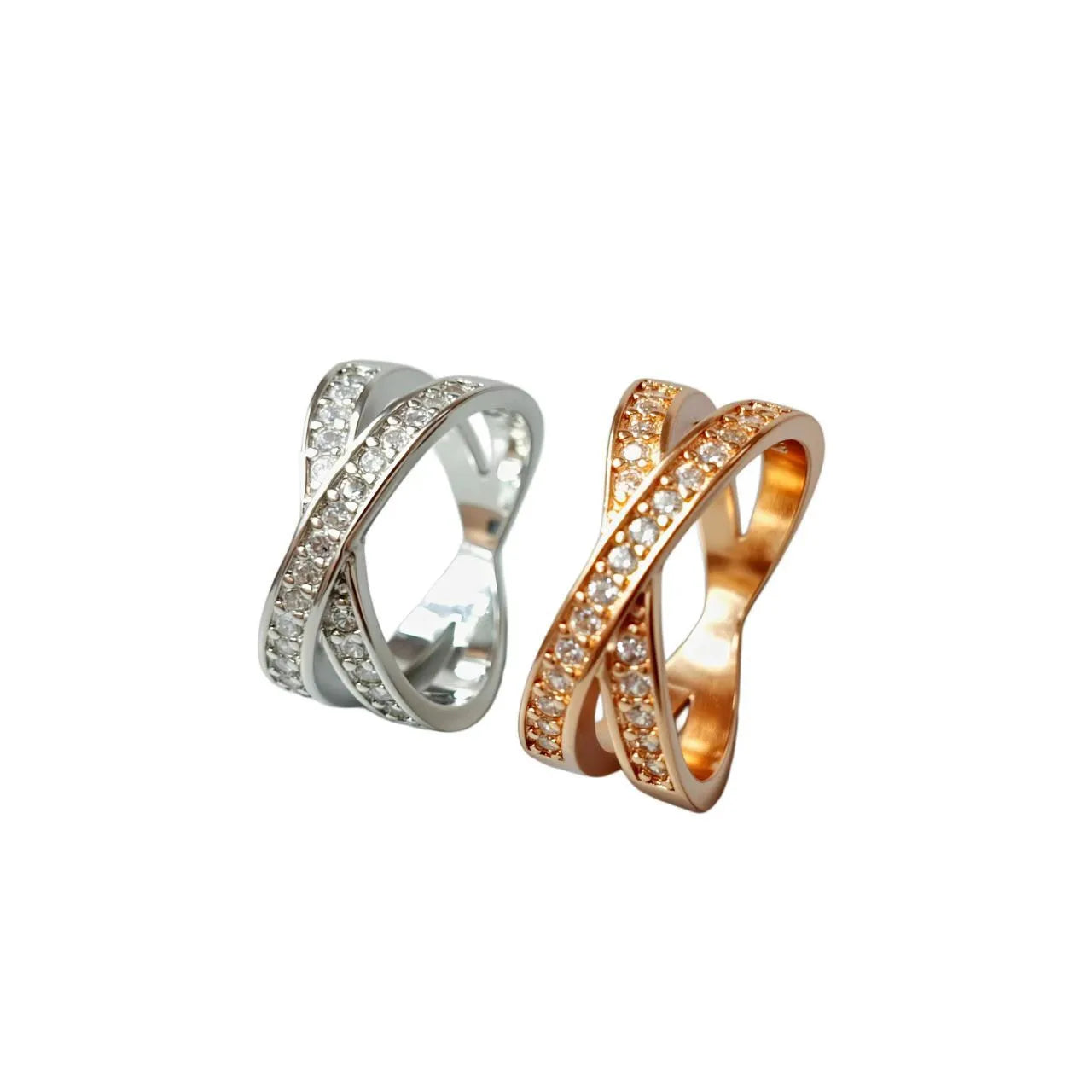 Geometric silver cross ring with micro-inlaid zircon stones on a model's finger.