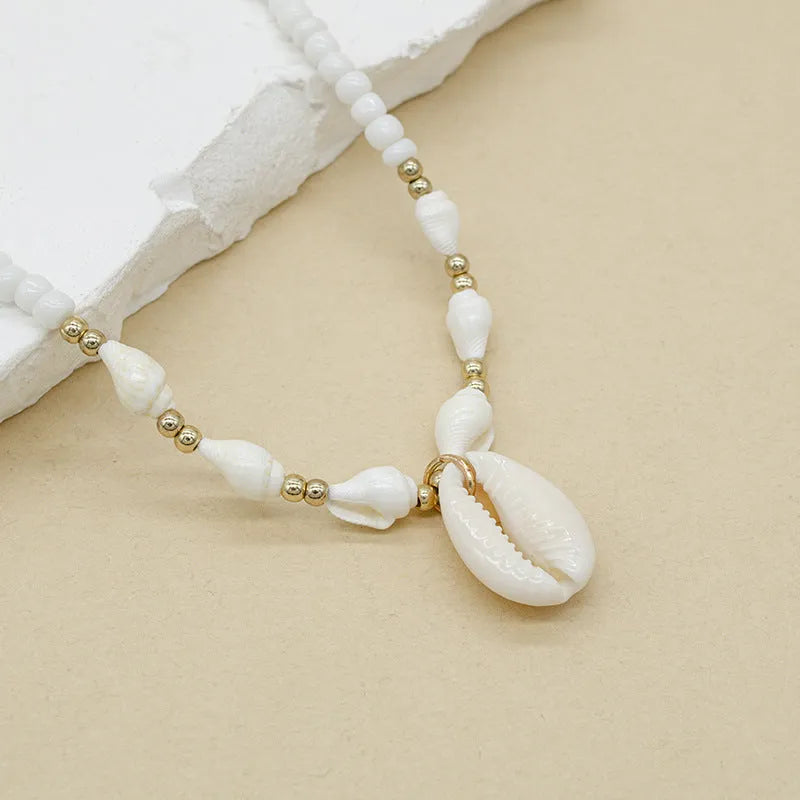 White conch shell necklace with mother-of-pearl pendant on regular chain