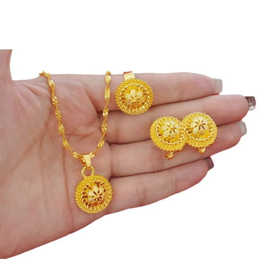 Gold-plated three-piece jewellery set with floral pendant necklace, matching ring and earrings