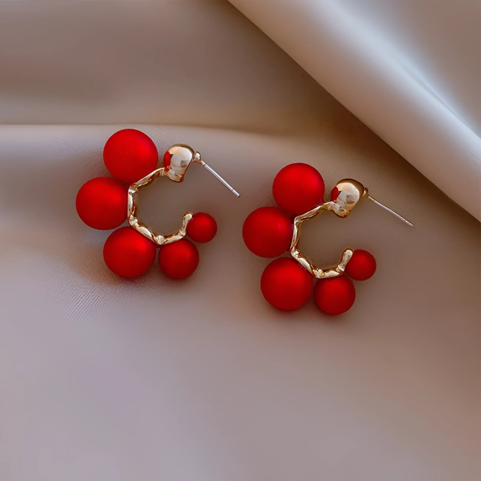 Red bell-shaped alloy drop earrings with gold-tone finish, approximately 2-3 cm length