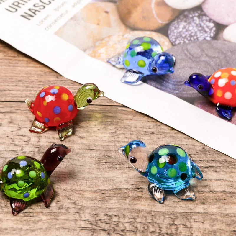 Glass geometric turtle ornament in blue head with blue shell colour variation on wooden desktop