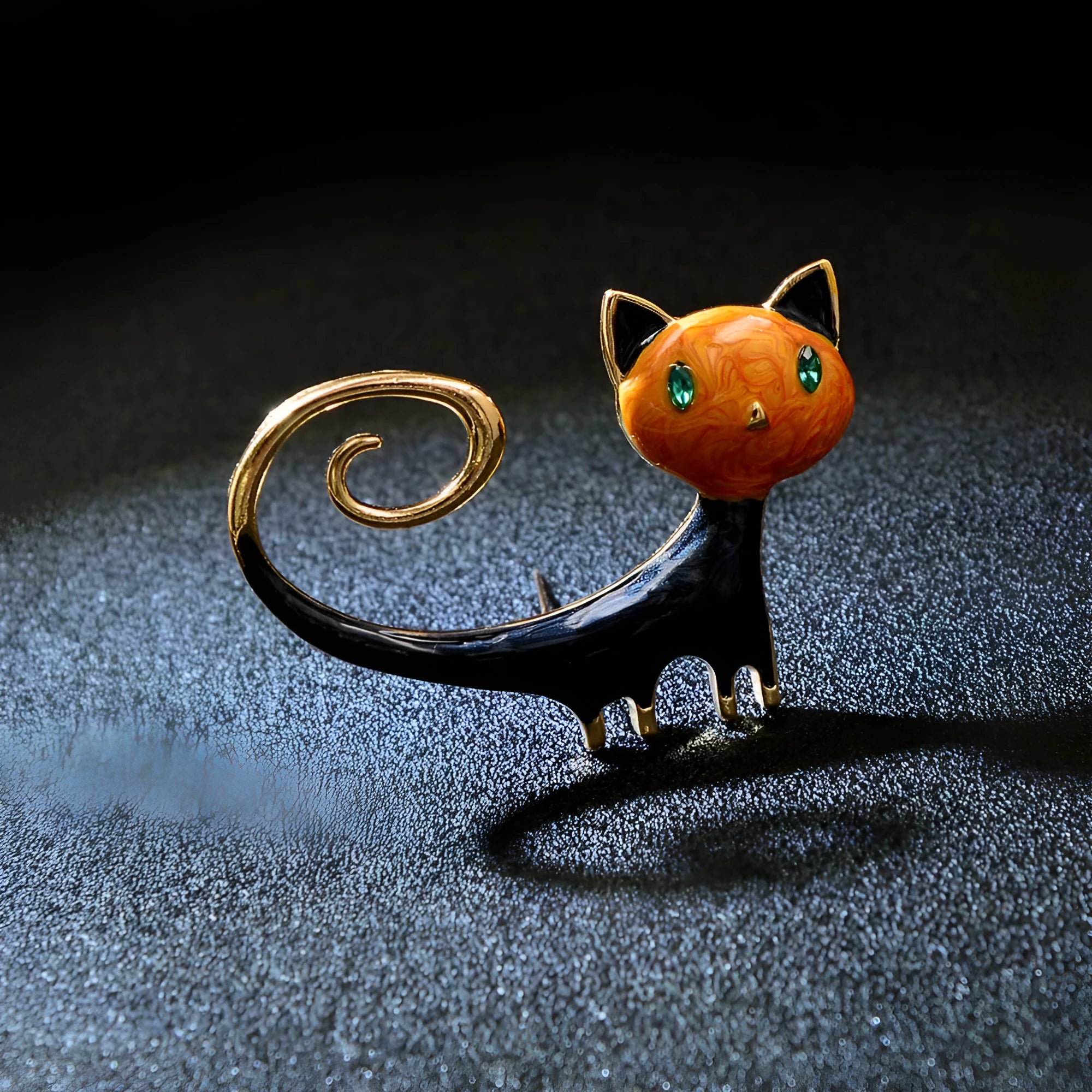 Close-up of a hand-painted tail-up kitten brooch in alloy metal, on a white background.