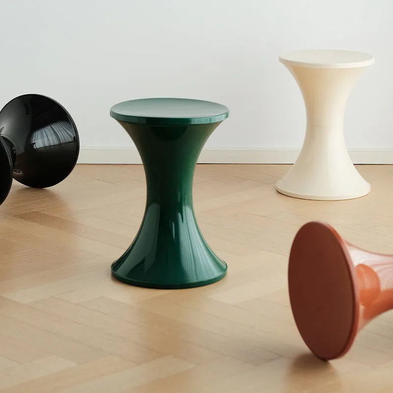 Plastic hourglass-style shoe changing stool shown in one of five colour options.