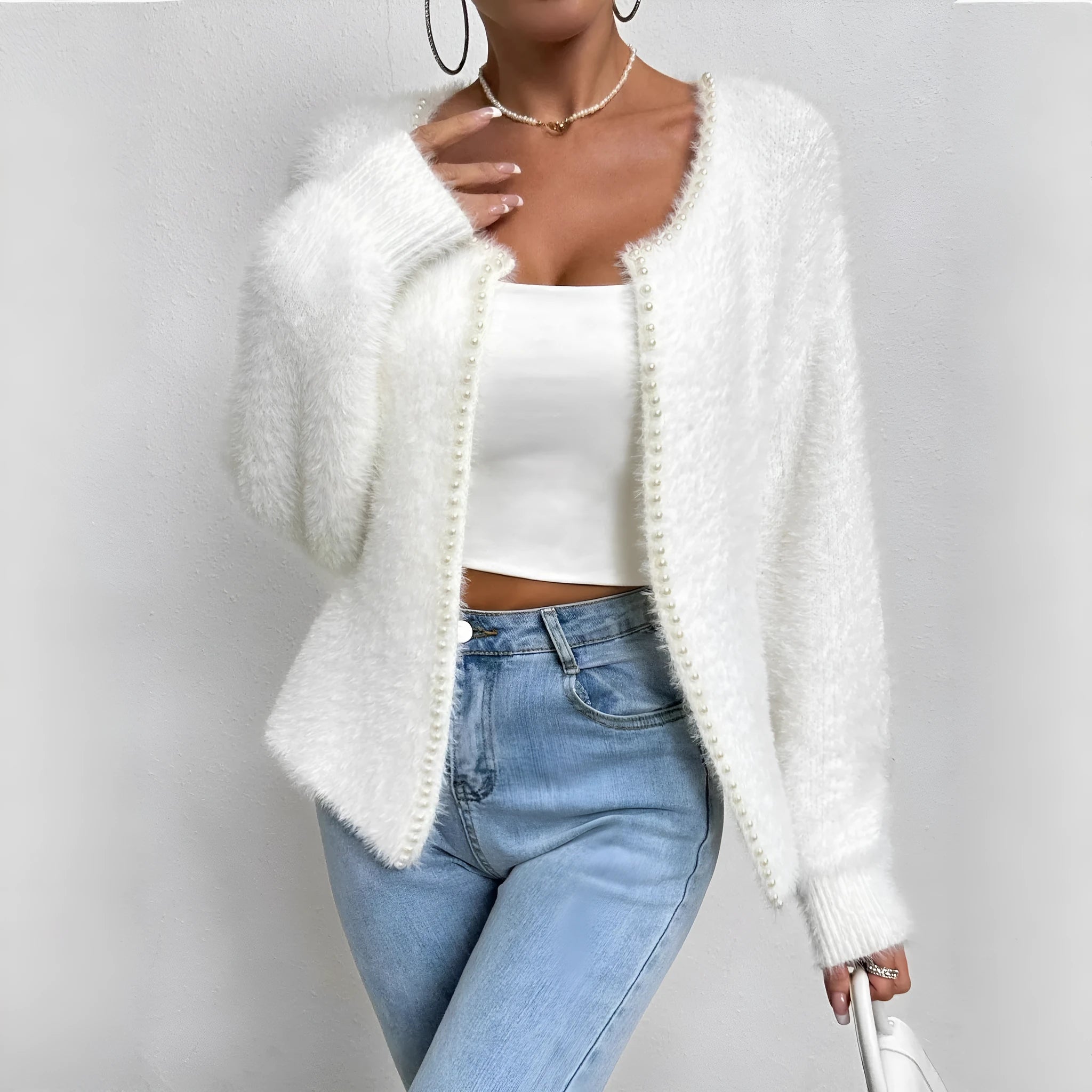 Women's white V-neck cardigan sweater made from polyester fabric.