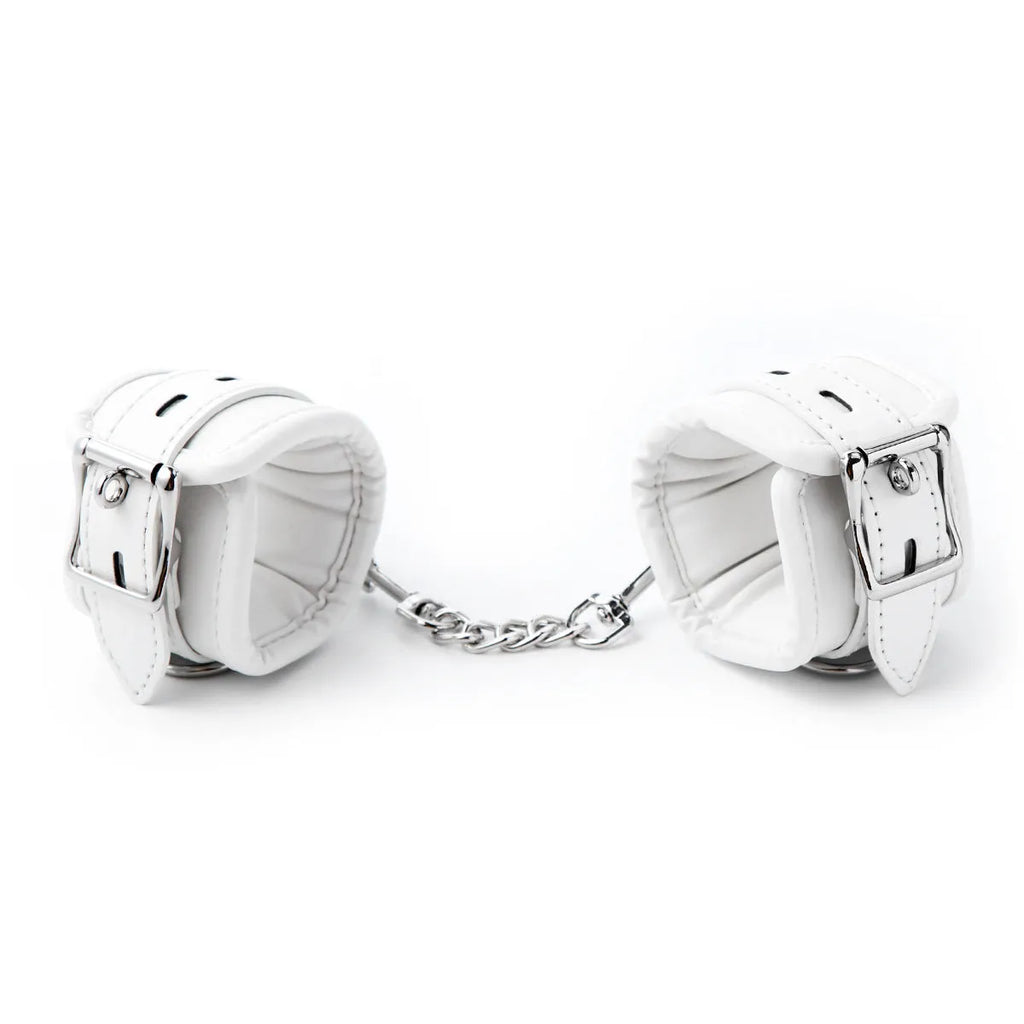 White PU sponge bondage set showing handcuffs, footcuffs and neck scarf with adjustable straps