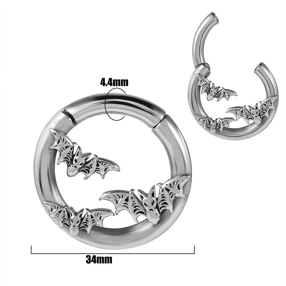 A pair of stainless steel fashion earrings with an intricate totem pattern design in a silver-toned finish.