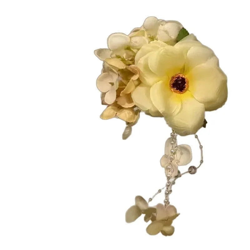 Yellow flower tassel side hair clip with manual craft details on white background