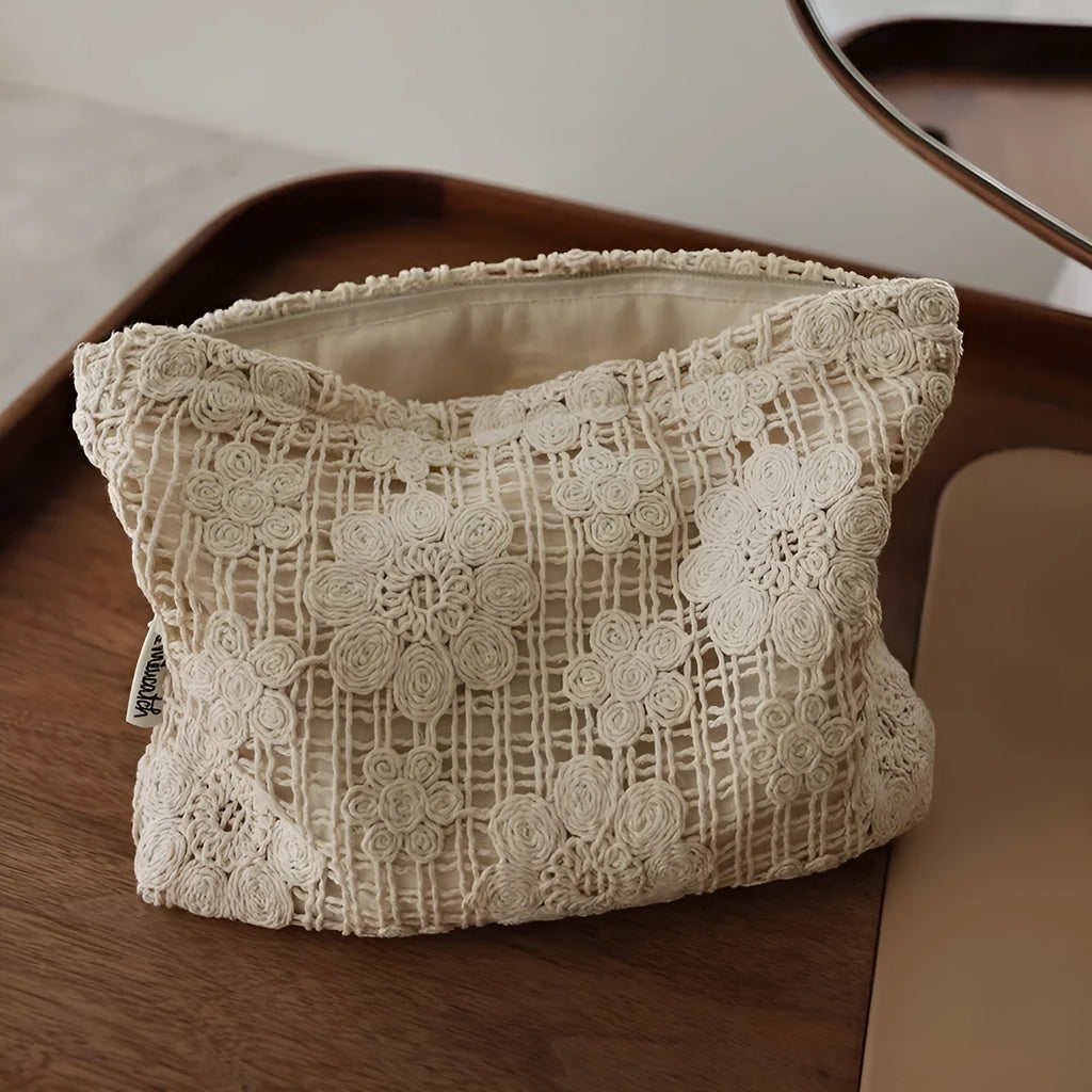Handmade corduroy cosmetic bag with crochet flowers, ethnic embroidery, and a rope handle.