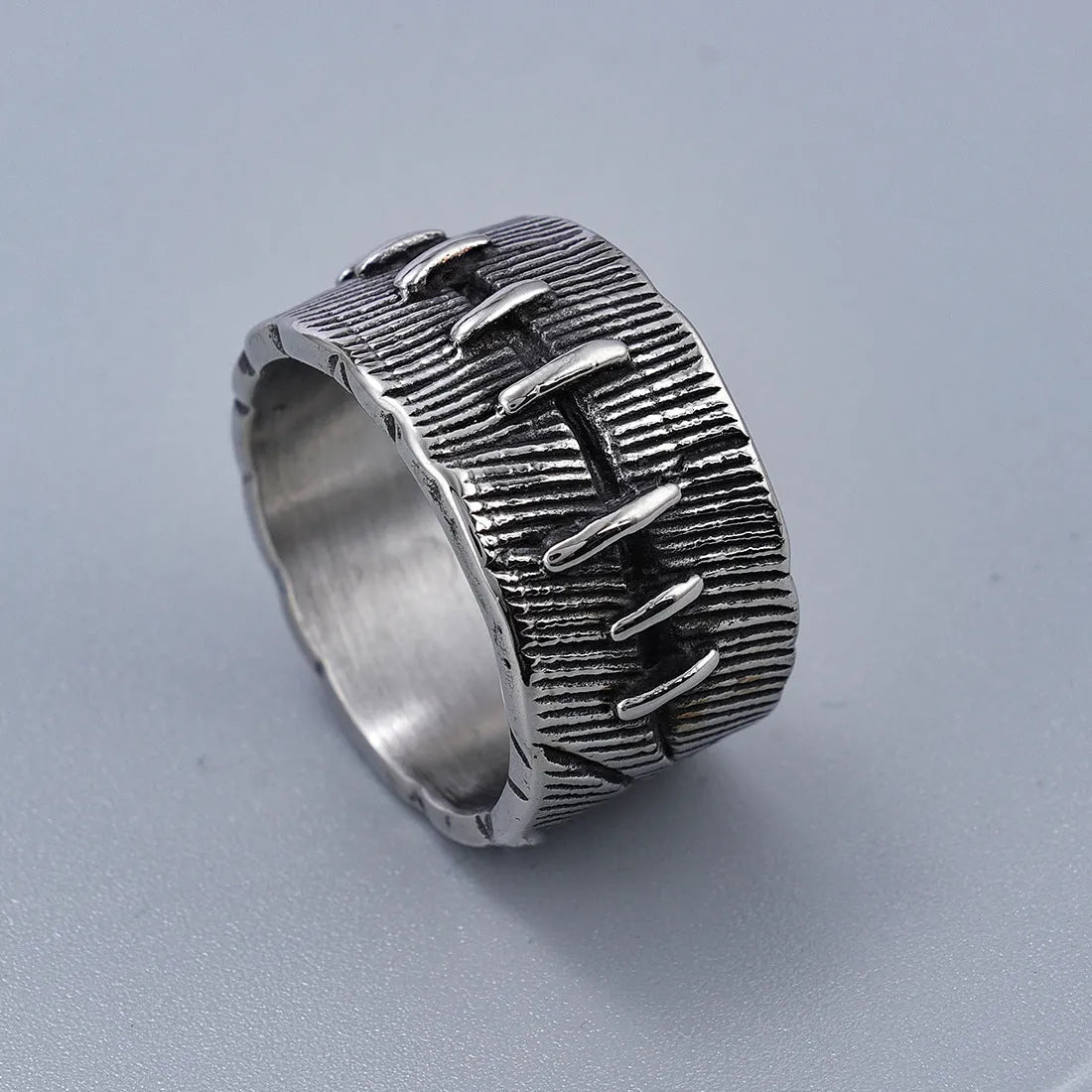 Titanium steel geometric U-shaped double ring in retro black colour, showing stitched design detail.