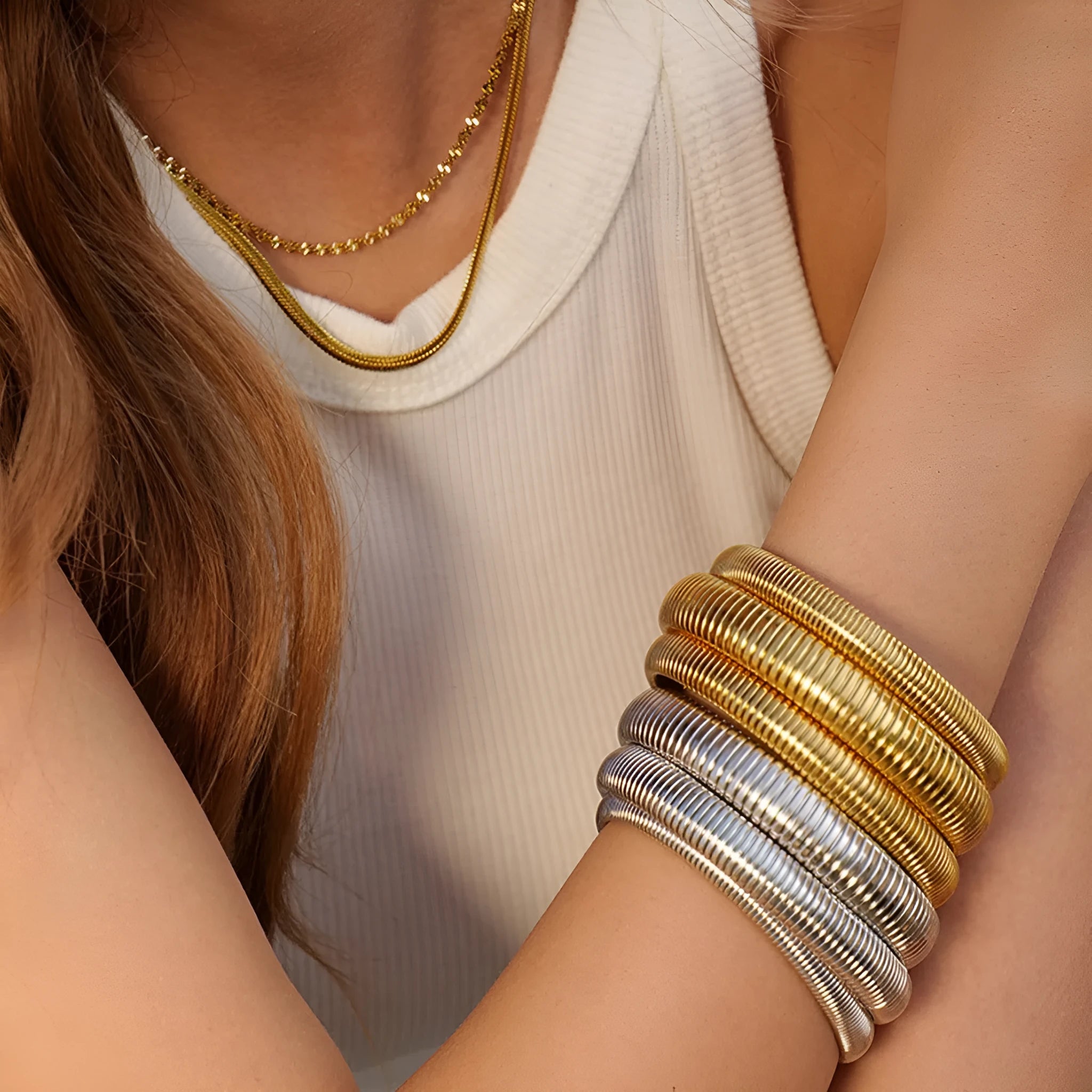 Women's gold titanium steel bracelet with exaggerated vertical stripe ring pattern and elastic band.