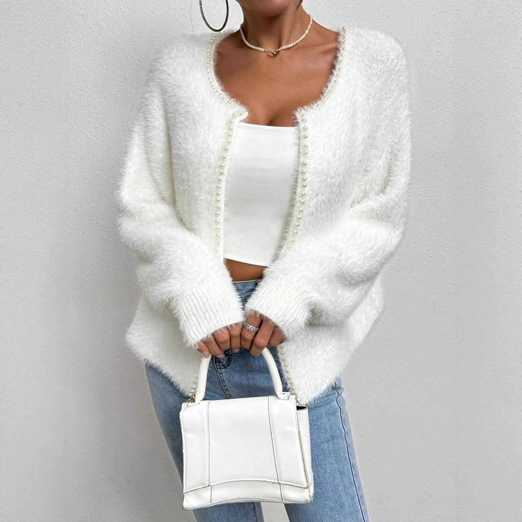 Women's white V-neck cardigan sweater made from polyester fabric.