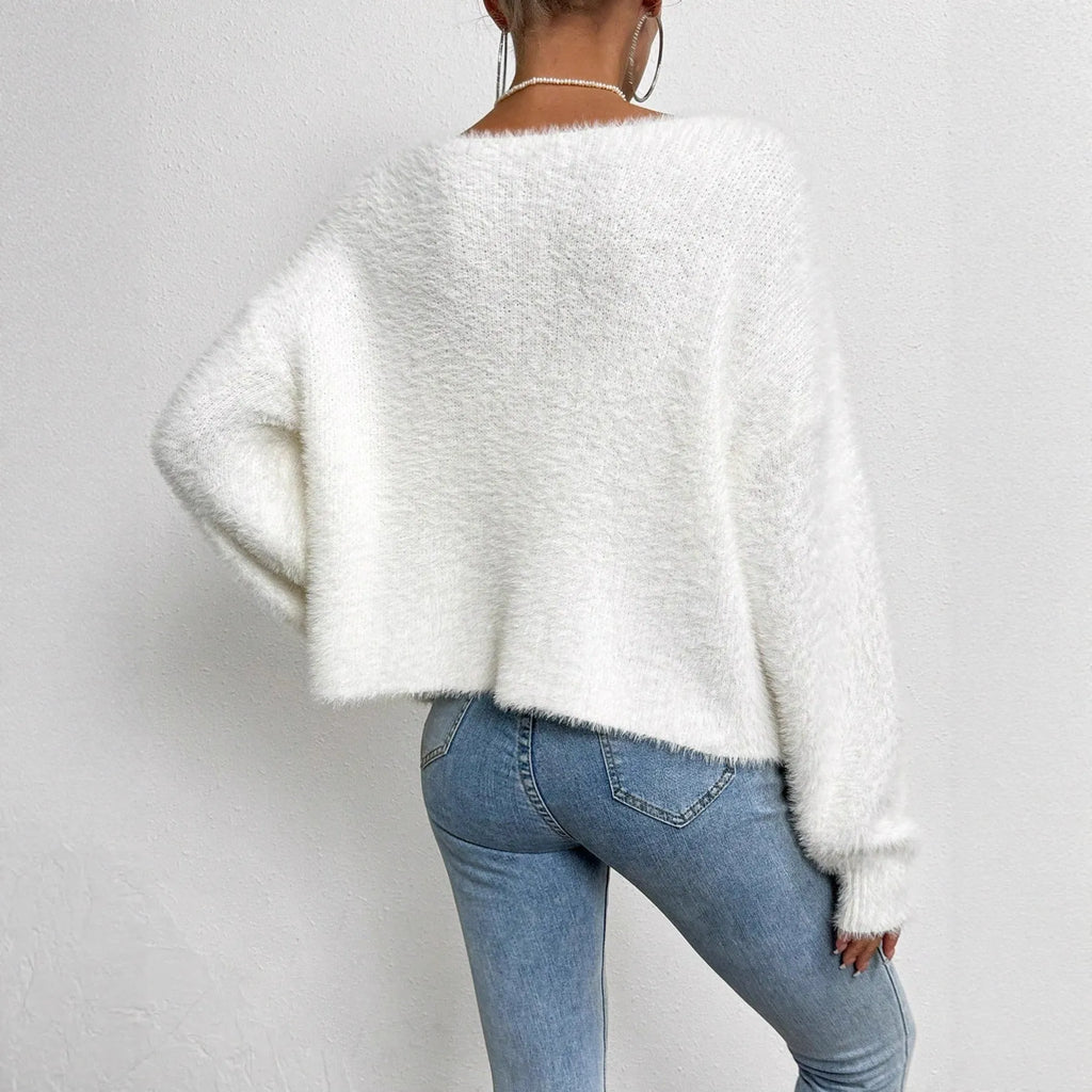 Women's white V-neck cardigan sweater made from polyester fabric.
