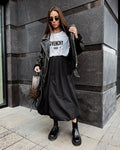 Women's solid colour cotton long skirt in black on a hanger.