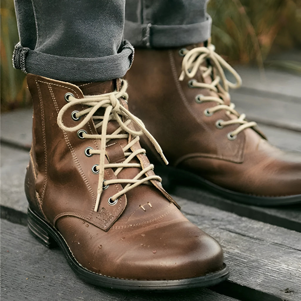 Men's black and brown two-tone leather ankle boots with a side zipper.