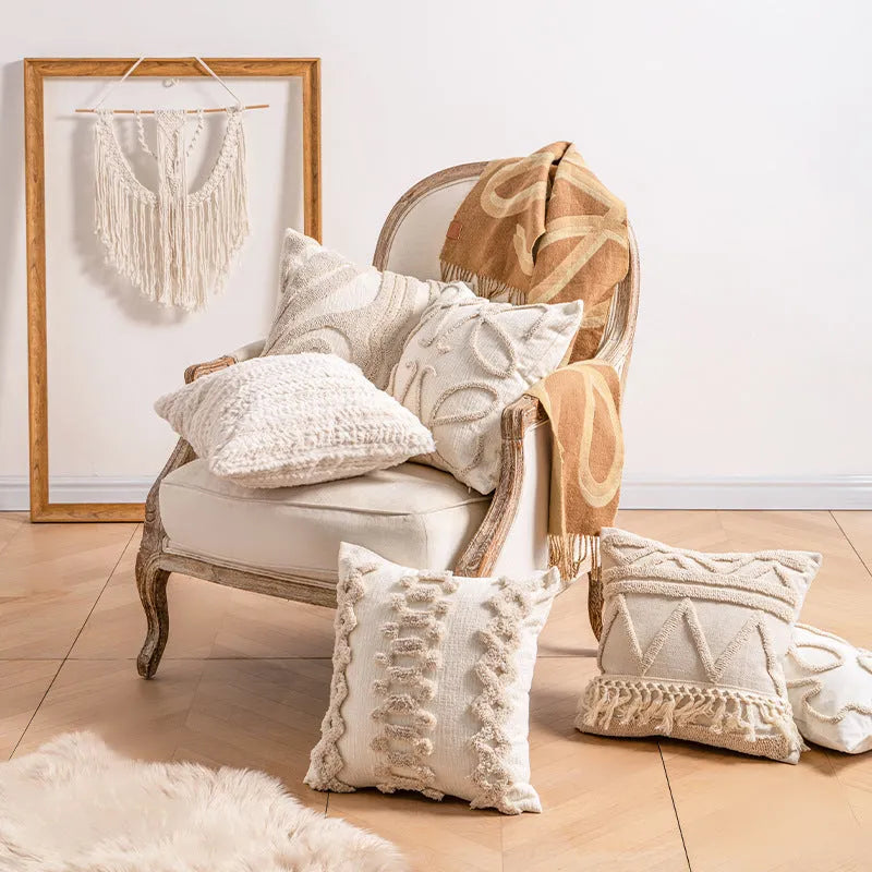Knitted tassel pillow cover in striped pattern on a sofa.