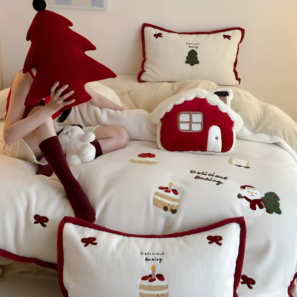 Winter Christmas cartoon snowman print bedding four-piece set on a single bed, showing duvet cover, pillowcases, and sheet.