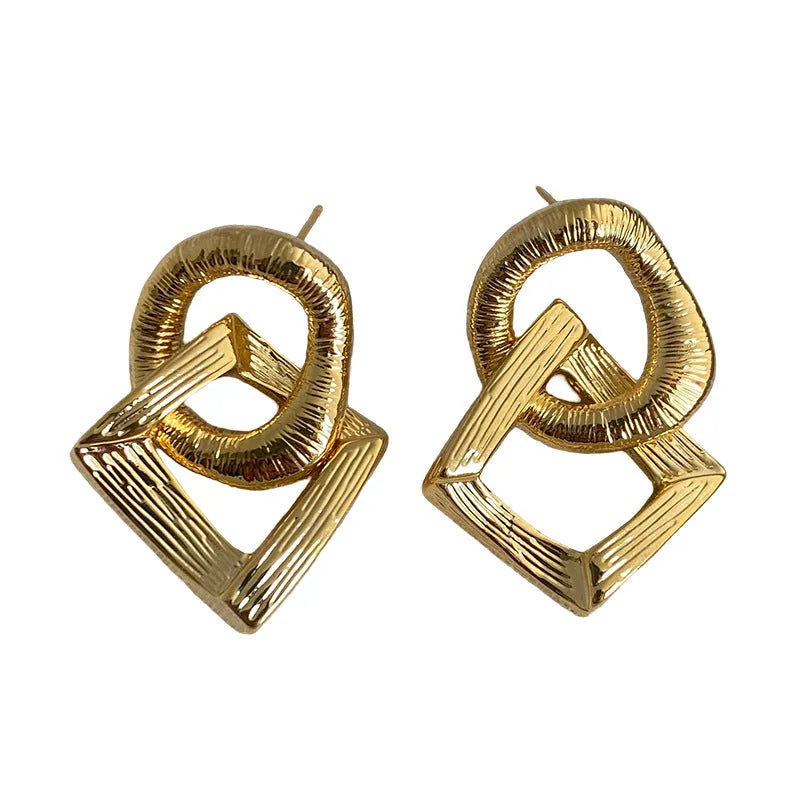 Gold and silver geometric pendant earrings with a 3.4cm retro design