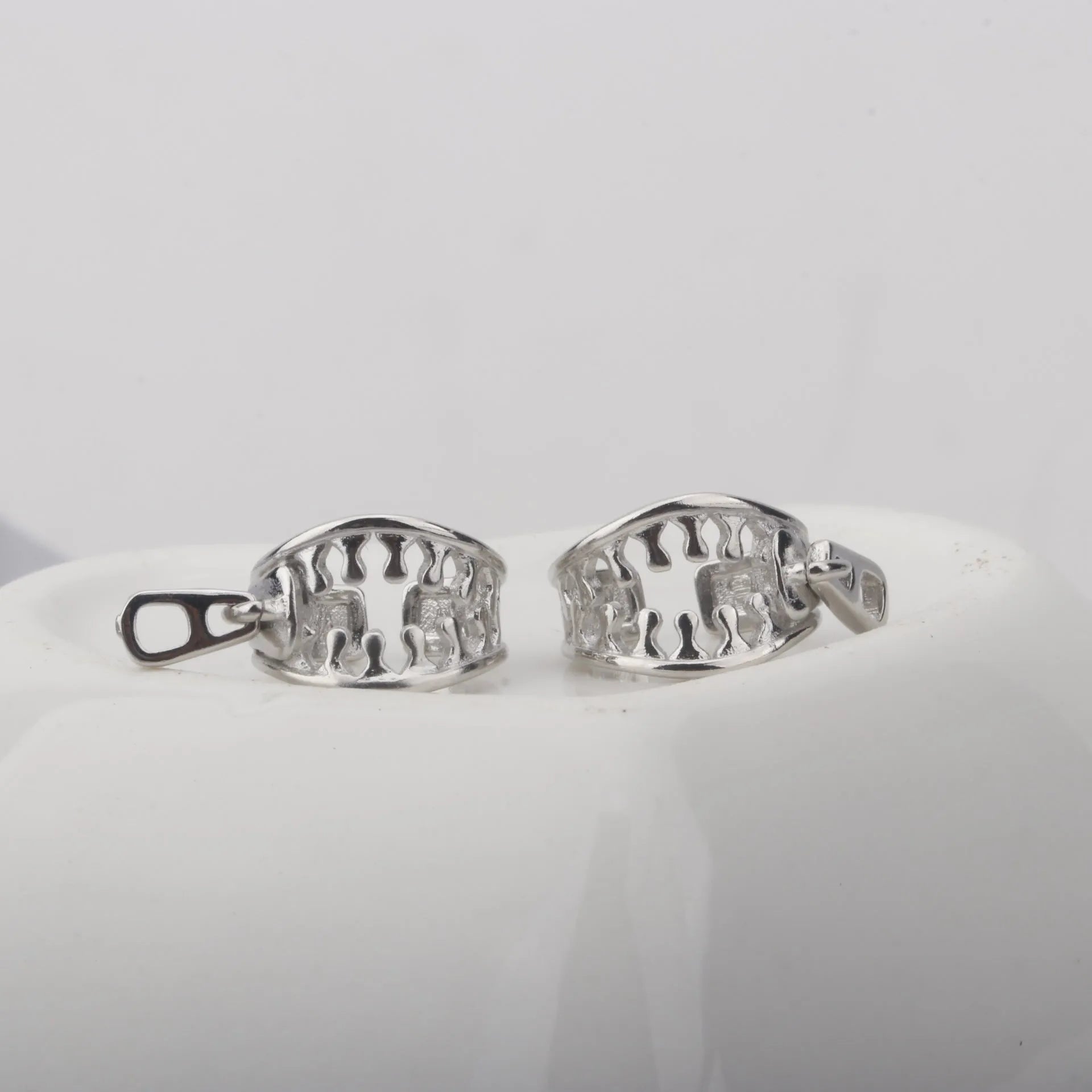 Copper geometric bone clip earrings with linear design on a white background.