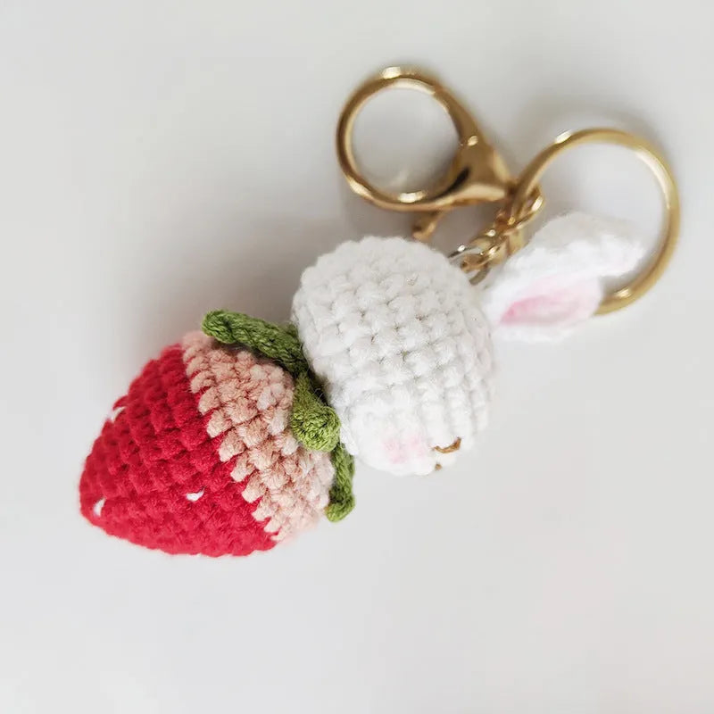 White hand-woven wire rabbit pendant with strawberry pattern and key