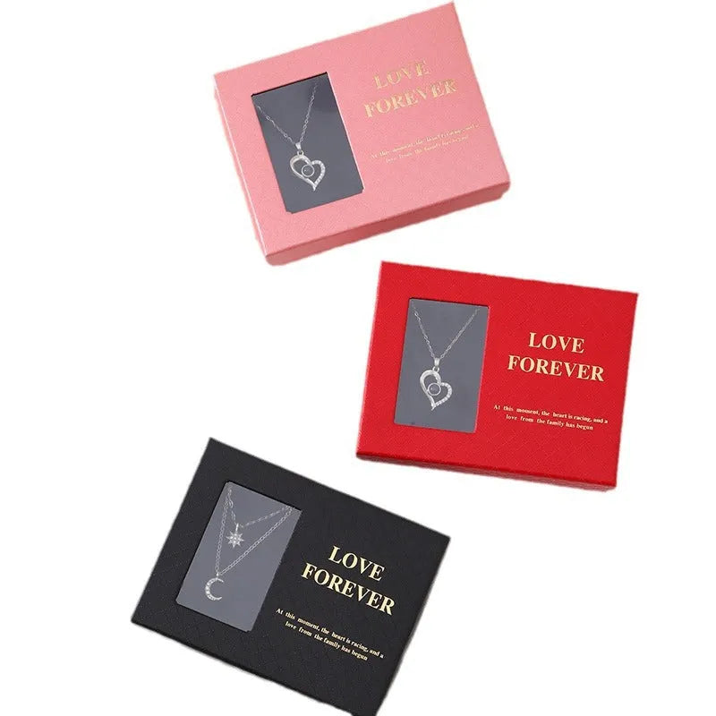 Korean style gift box open to show six red soap flowers, with a handbag beside it.