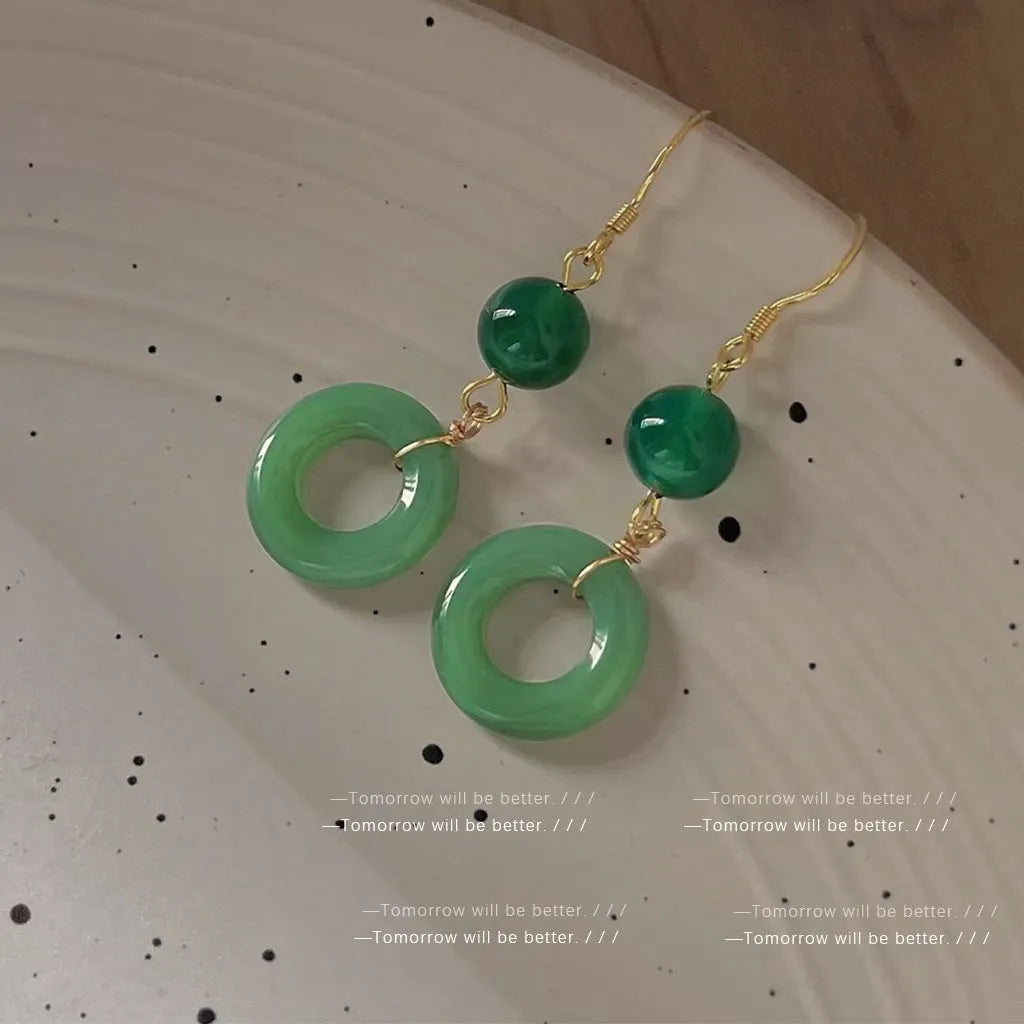 Green geometric peace buckle earrings with 14K gold plating on a zinc alloy base.