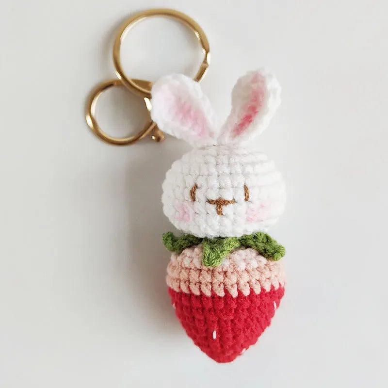 White hand-woven wire rabbit pendant with strawberry pattern and key