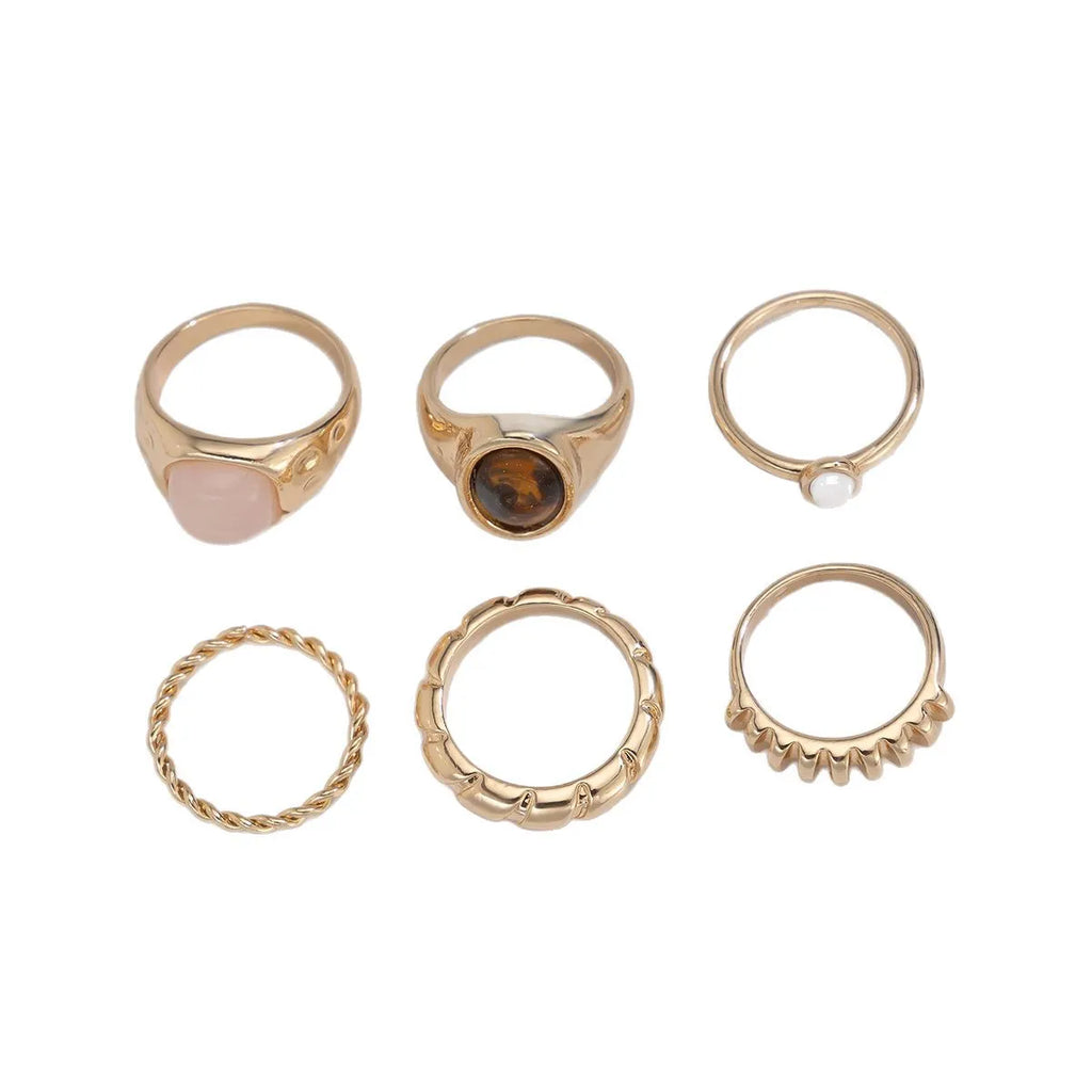 Six geometric alloy rings with electroplated light gold finish displayed as a jewellery set