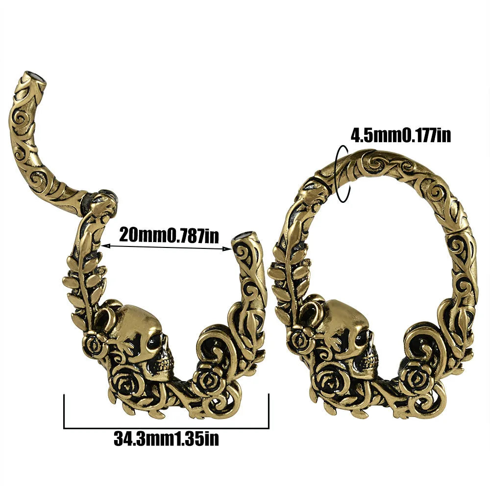 A pair of stainless steel fashion earrings with an intricate totem pattern design in a silver-toned finish.