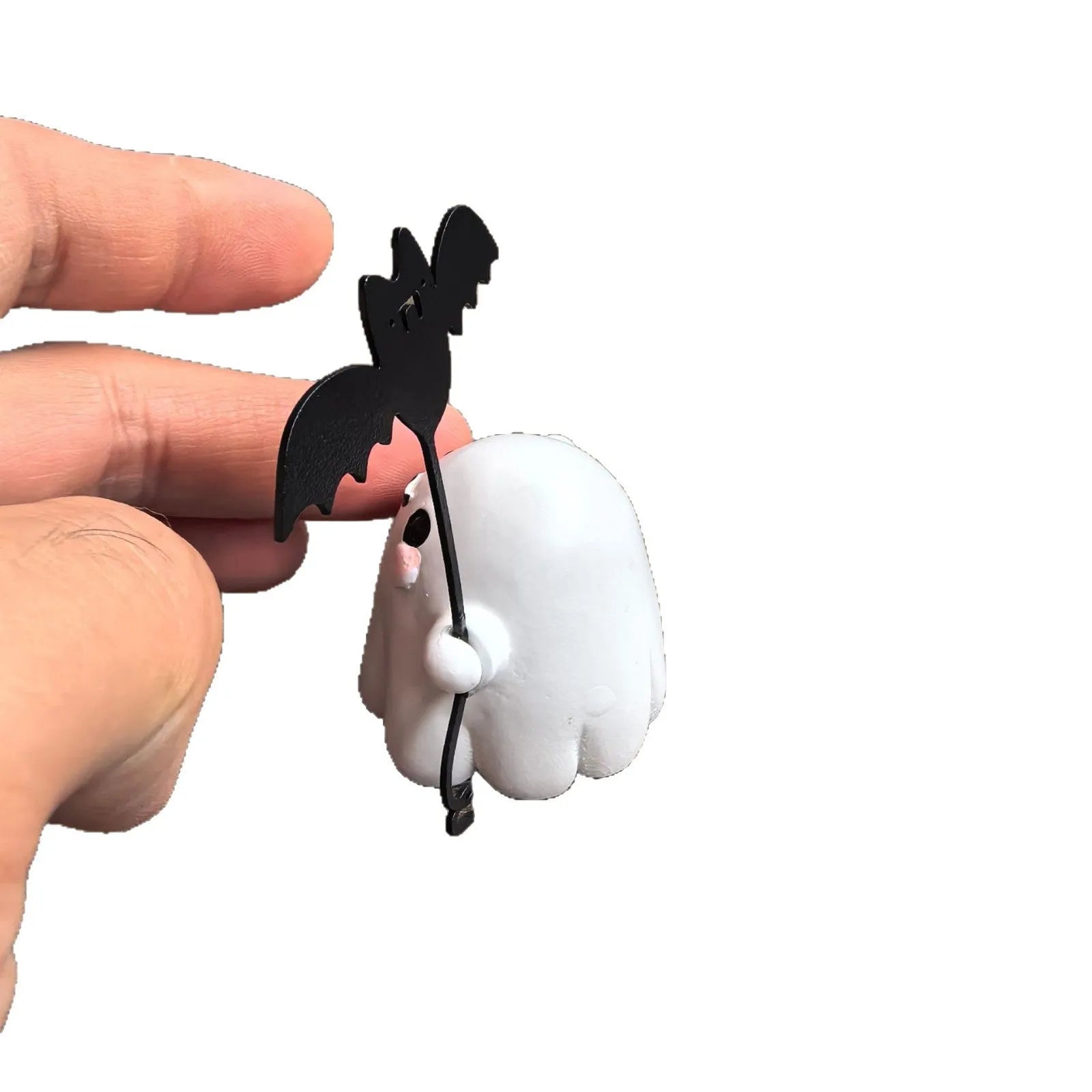 Miniature resin statue of a ghost walking a dog and holding a bat, a 4cm tall Halloween decoration.