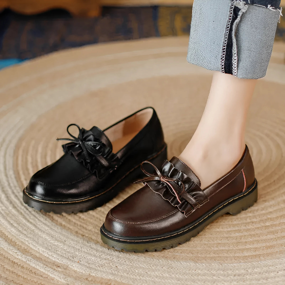 Women's black leather shoes with a chunky heel and round toe, showing the low-top design and cowhide upper.