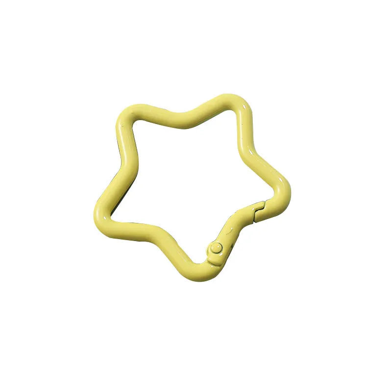Zinc alloy five-pointed star keychain charm in assorted colours including light pink, blue, and black.