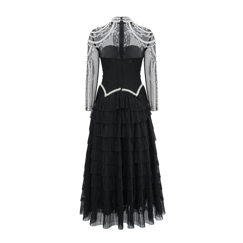 Women's black long sleeve beaded formal dress with mid waist and full-length skirt.