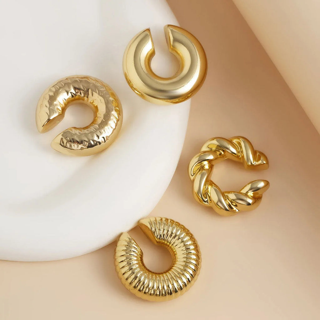 Geometric clip-on ear cuff set in gold and silver colours, four pieces displayed
