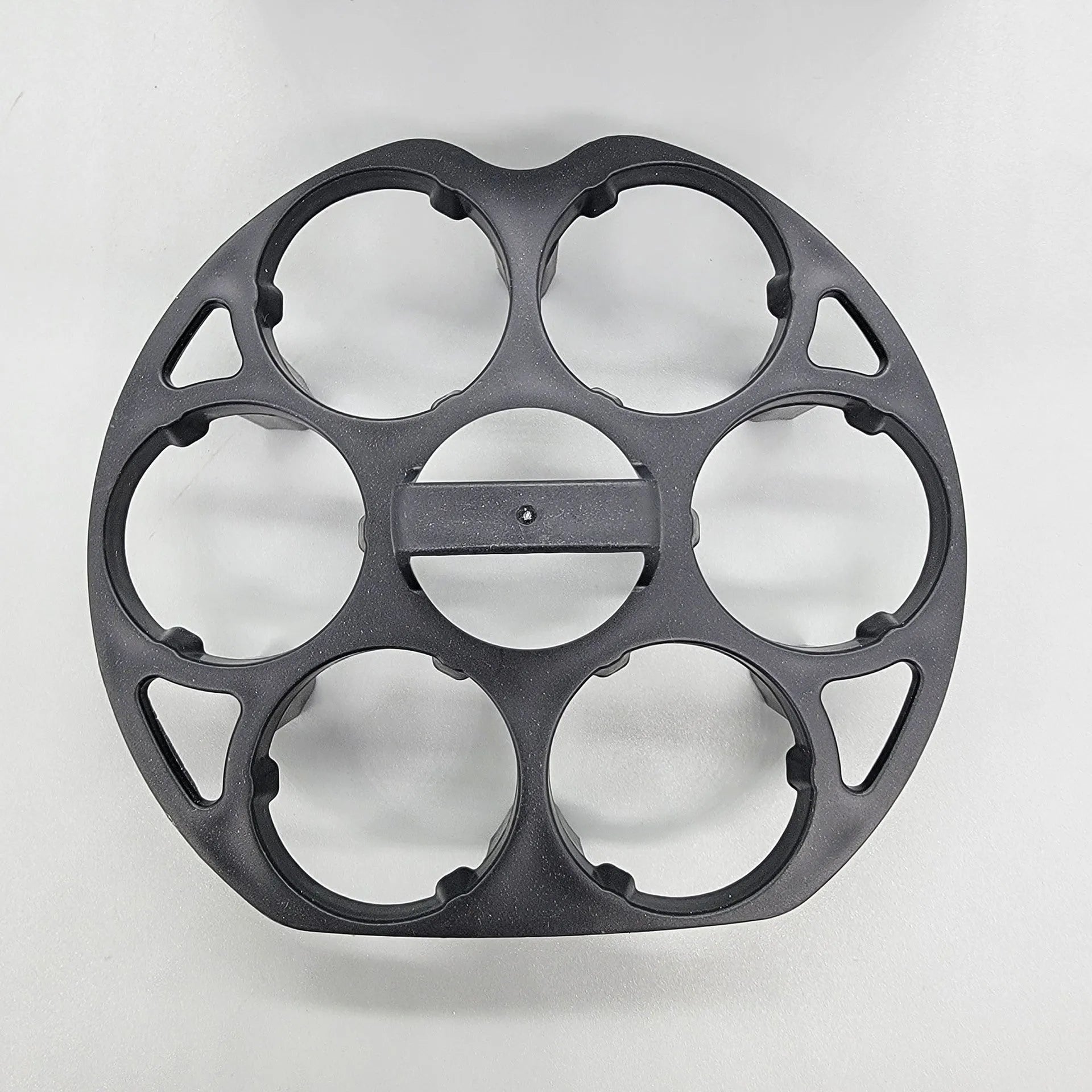 Black plastic egg holder rack with modern design for kitchen organisation.