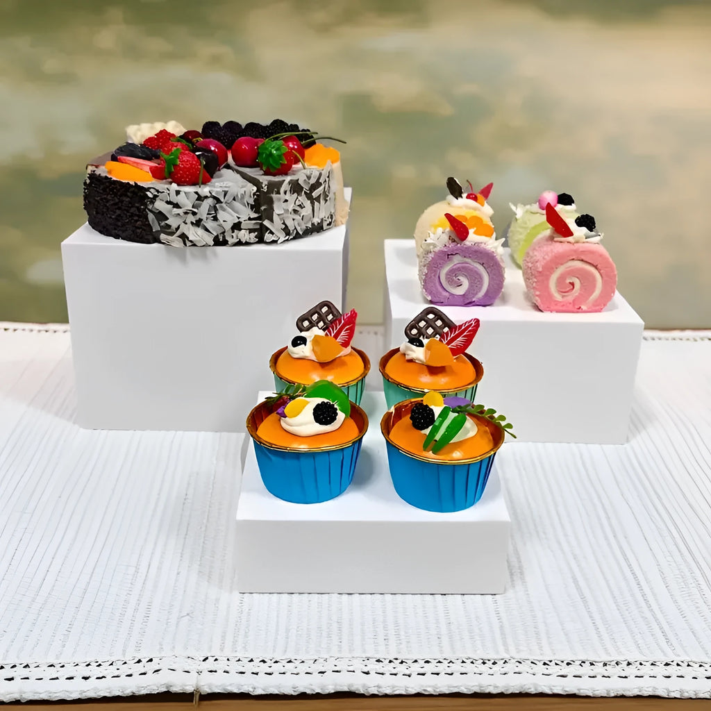 Set of six white plastic cube display stands arranged on a wooden tabletop.
