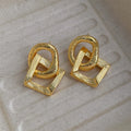 Gold and silver geometric pendant earrings with a 3.4cm retro design