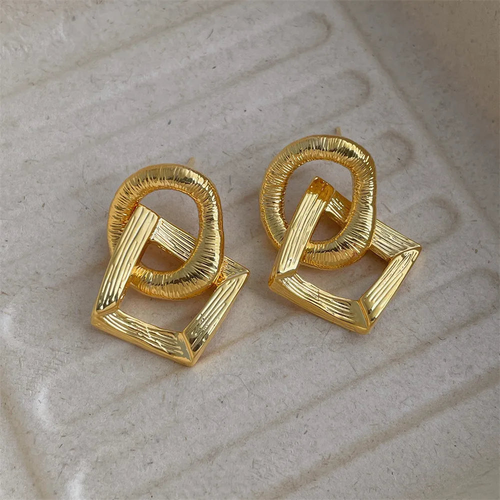 Gold and silver geometric pendant earrings with a 3.4cm retro design