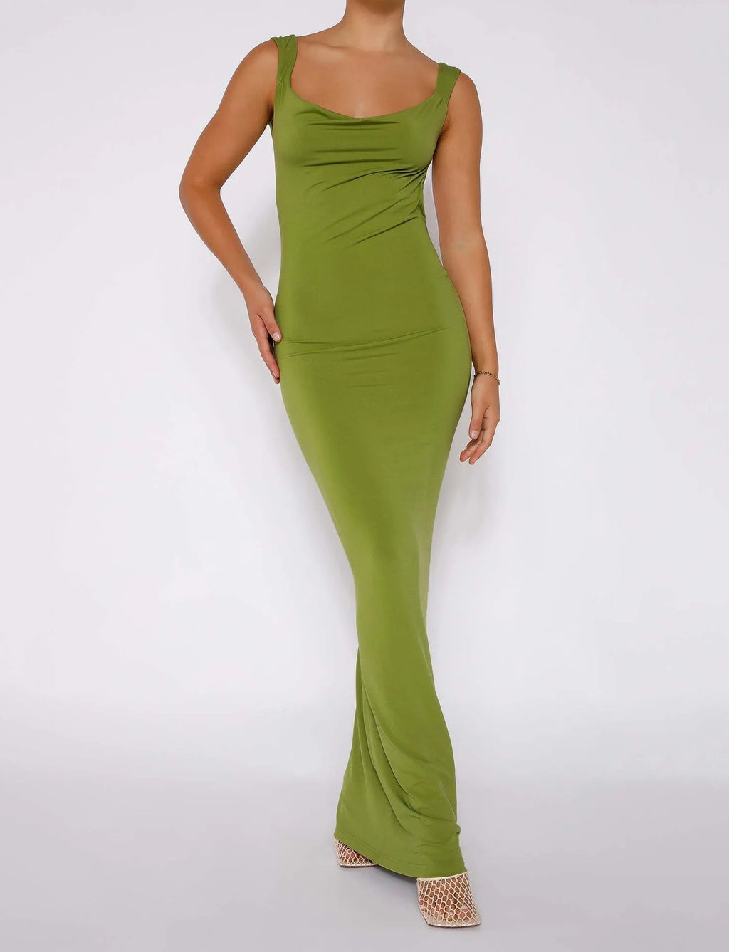 Backless slim fit milk silk sling dress in champagne colour on a model.
