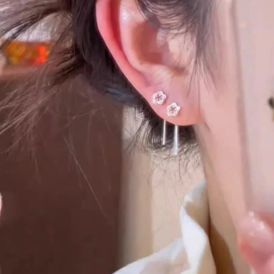 Pair of silver-coloured alloy flower stud earrings with hollow petal design