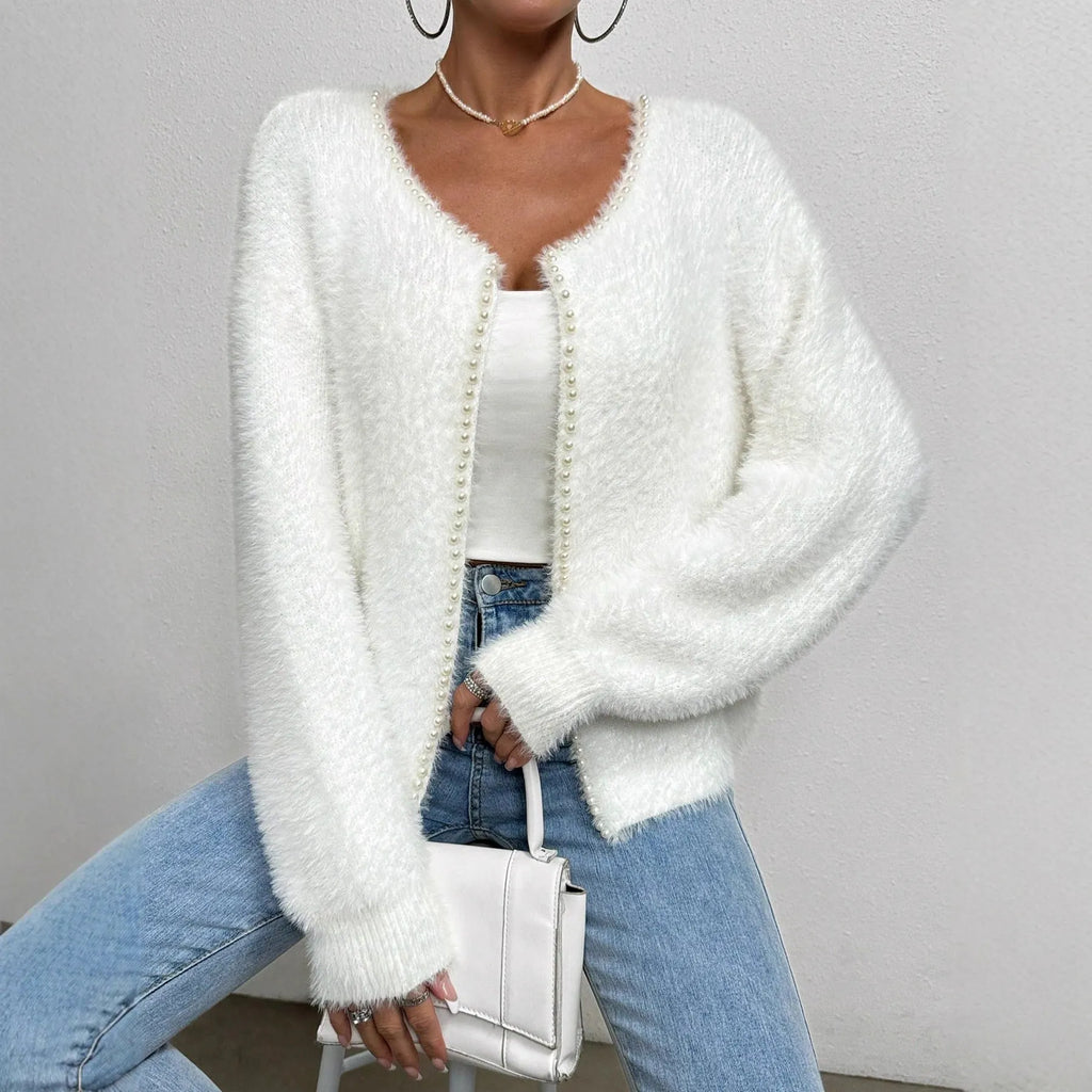 Women's white V-neck cardigan sweater made from polyester fabric.