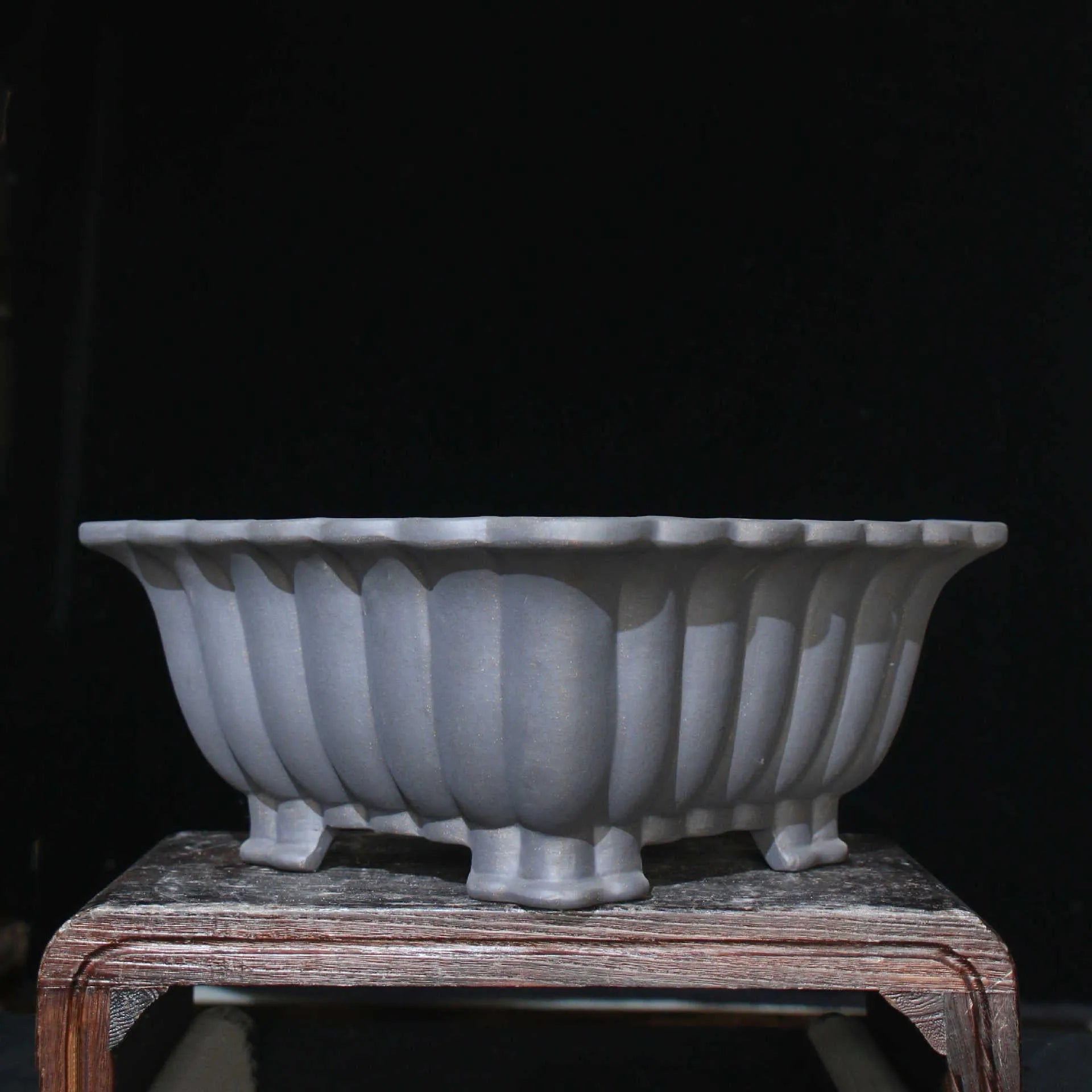 Square purple sand ceramic bonsai pot with warp device on a desktop.