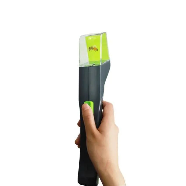 Green plastic handheld insect catcher for garden and lawn pest control.
