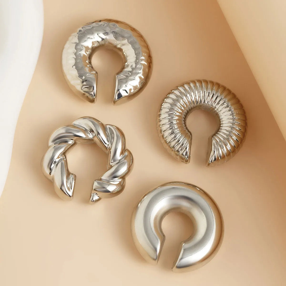Geometric clip-on ear cuff set in gold and silver colours, four pieces displayed