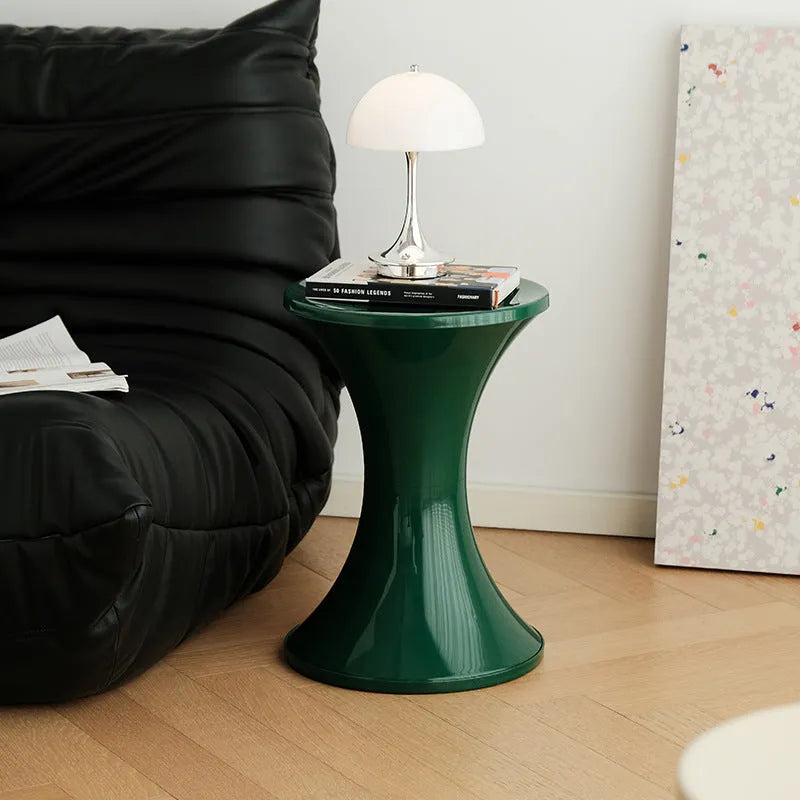 Plastic hourglass-style shoe changing stool shown in one of five colour options.